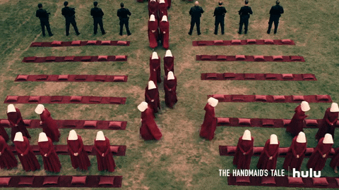 Handmaid's Tale gif, women in cloaks and hats filing into a ceremonial site