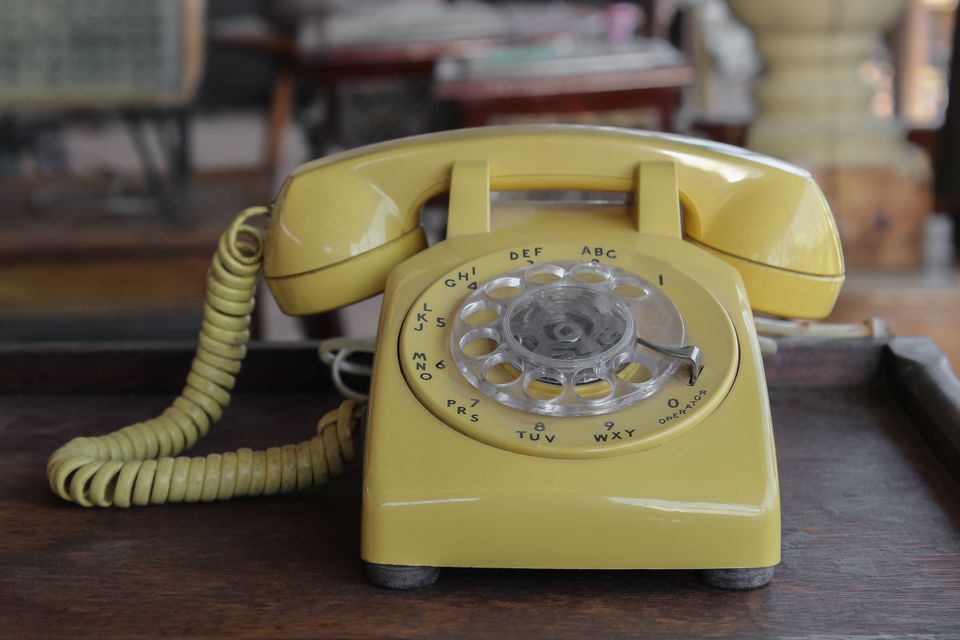 Yellow handset telephone, rotary dial, probably from the 1960s?