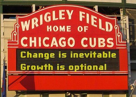Wrigley Field marquee, old school white font on red background.  LED sign says, "Change is inevitable/Growth is optional"